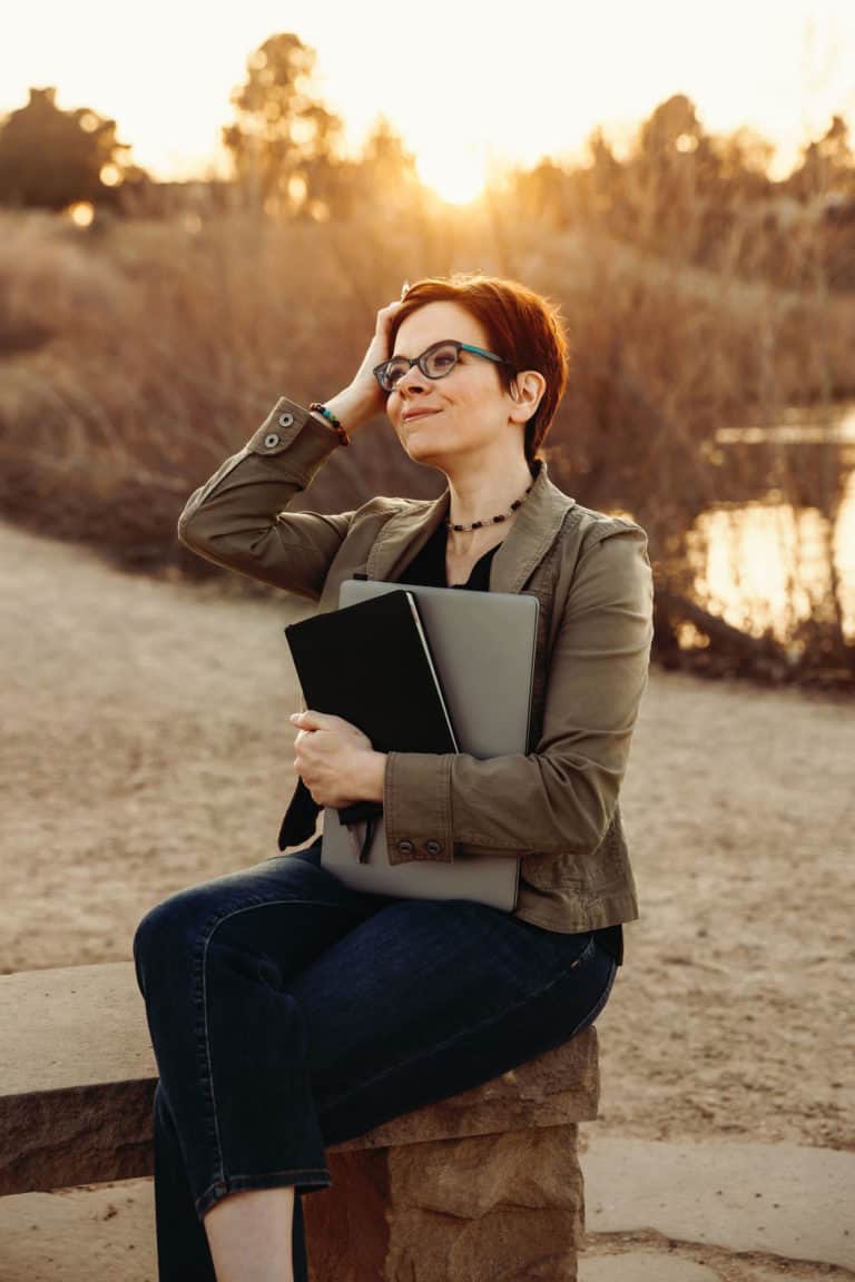 Email copywriter, Karen Kossow looks into the distance with the sun going down behind her